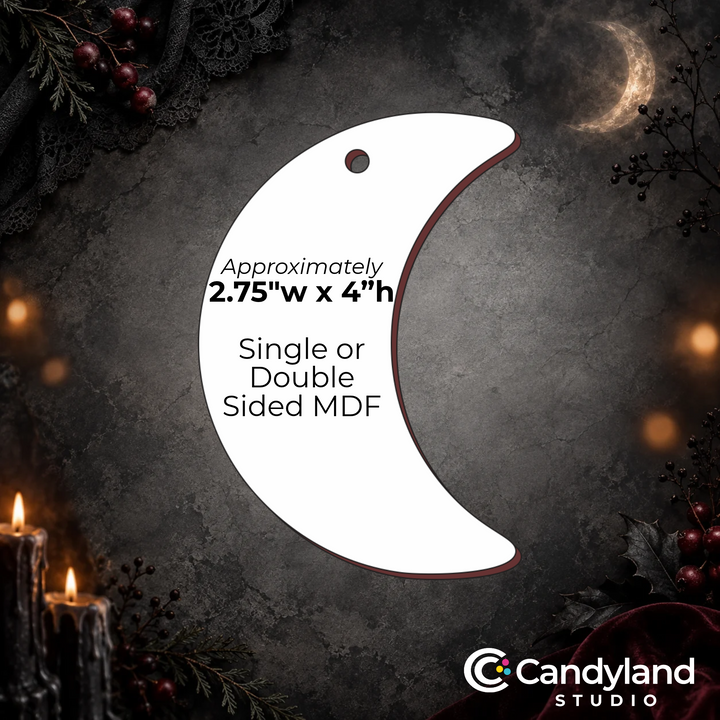 a crescent moon-shaped ornament with a candle and berries in the background.